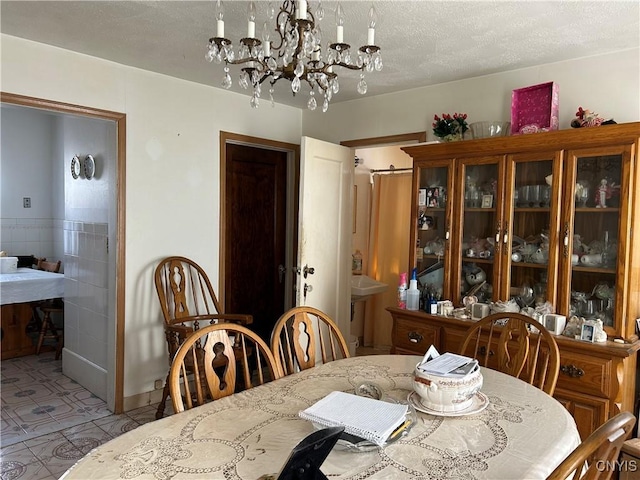 dining room with a notable chandelier and a textured ceiling