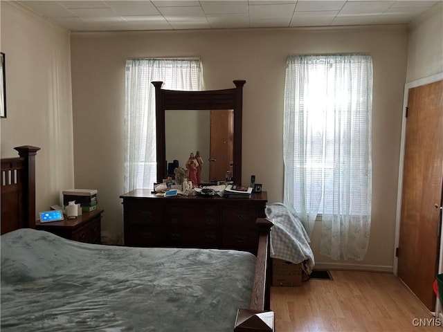 bedroom with wood finished floors and visible vents