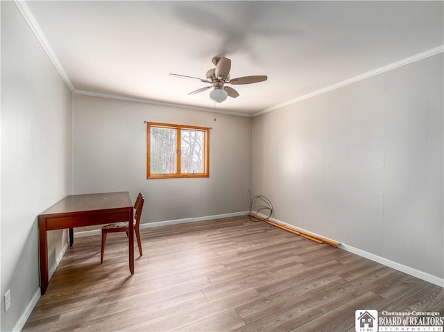 unfurnished office featuring ceiling fan, ornamental molding, light wood-type flooring, and baseboards