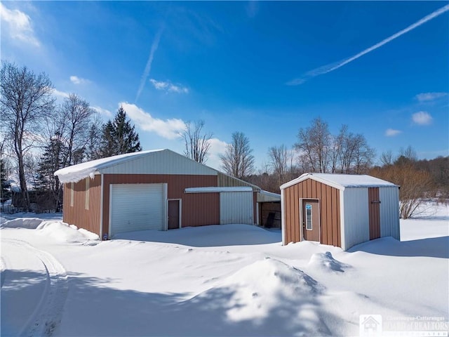 snow covered garage with a garage