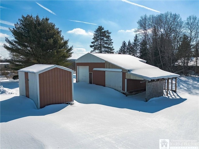 exterior space with a detached garage and an outdoor structure