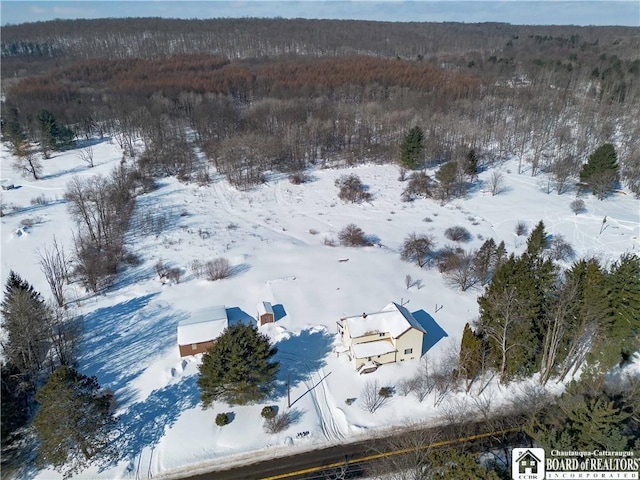 snowy aerial view with a view of trees