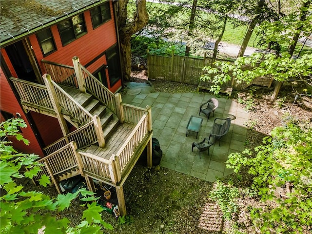 wooden terrace featuring central AC unit and a patio area