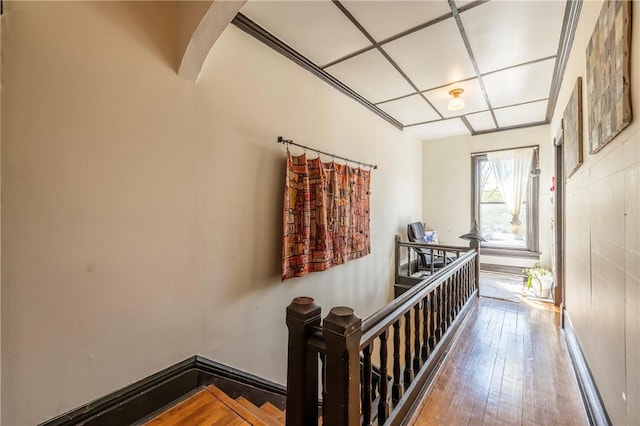 hallway with hardwood / wood-style flooring