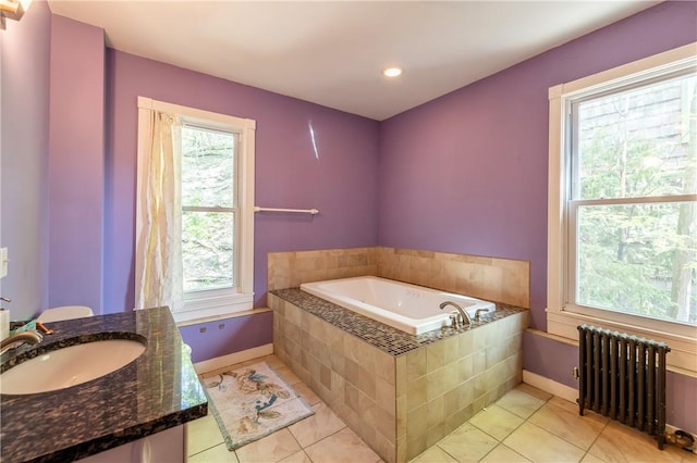 full bath featuring a garden tub, radiator heating unit, tile patterned floors, and a wealth of natural light