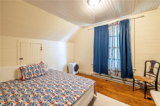 bedroom with lofted ceiling, wood ceiling, and wood finished floors