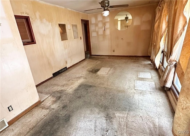 unfurnished dining area featuring a ceiling fan and baseboards