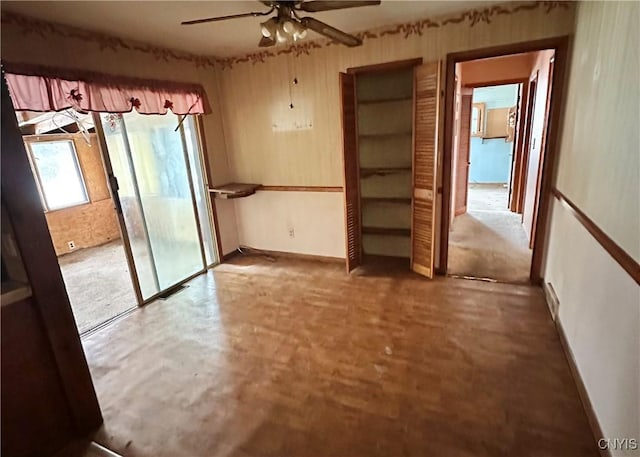 spare room with ceiling fan and concrete flooring