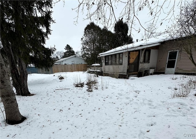 yard layered in snow with fence