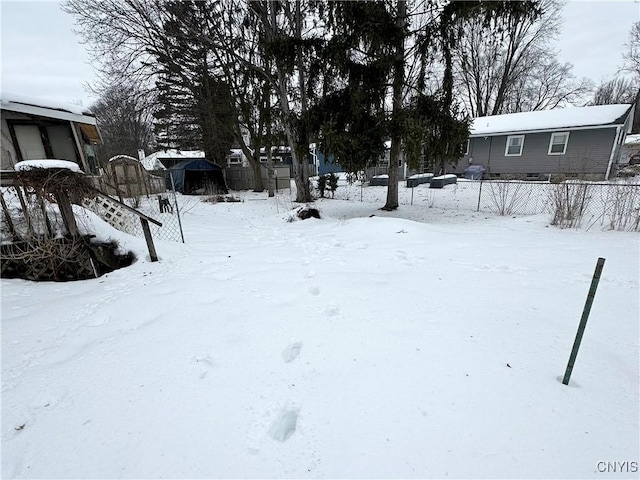 yard layered in snow featuring a garage