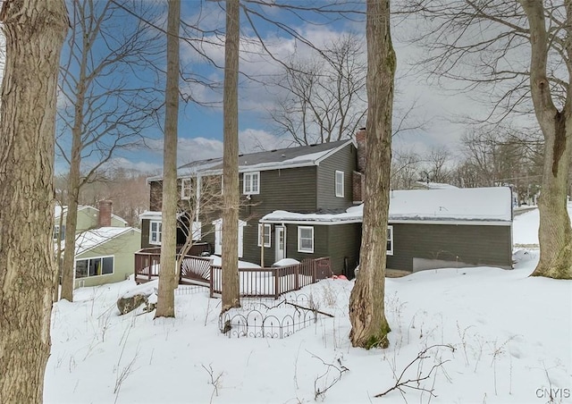 view of front of home featuring a deck and a chimney