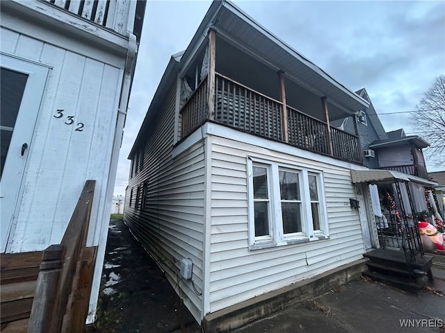 view of side of property with a balcony