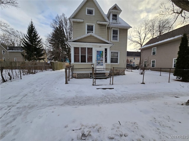 snow covered house with fence