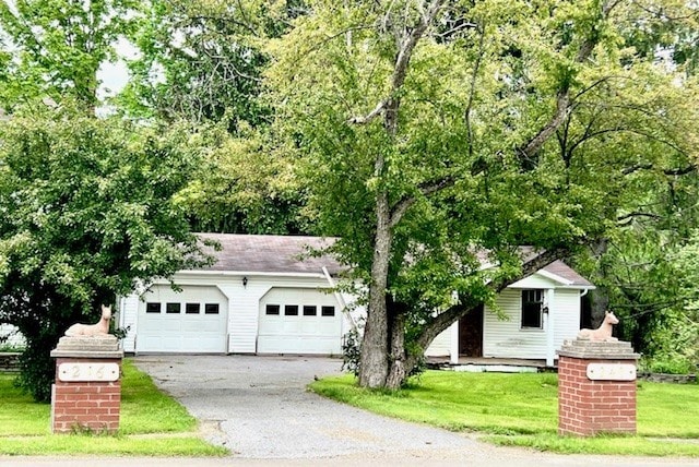 246 S Marvin St, Smethport-Borough, PA 16749 - view of front facade with driveway, a front lawn, and an attached garage