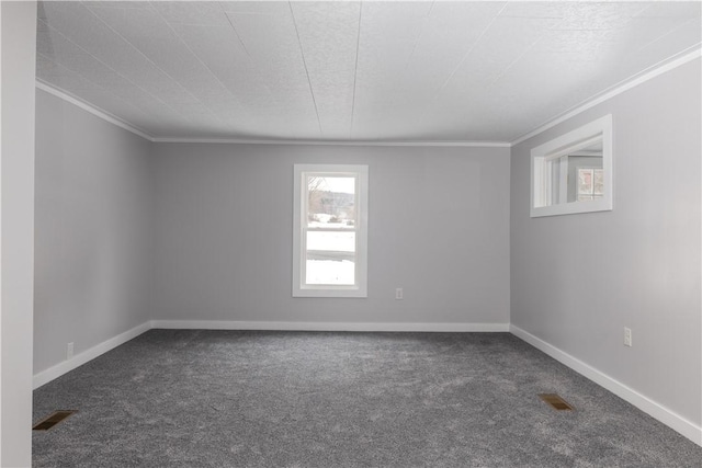 unfurnished room featuring ornamental molding, dark carpet, visible vents, and baseboards