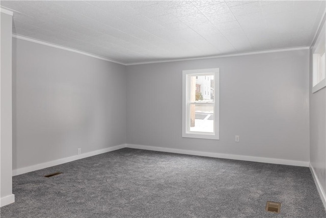 unfurnished room featuring carpet, visible vents, crown molding, and baseboards