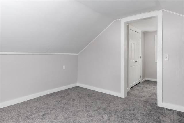 additional living space with lofted ceiling, carpet flooring, and baseboards