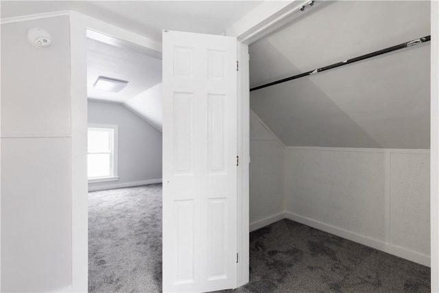 additional living space with carpet floors, lofted ceiling, and baseboards