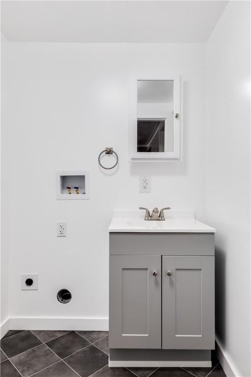 bathroom with tile patterned flooring, baseboards, and vanity