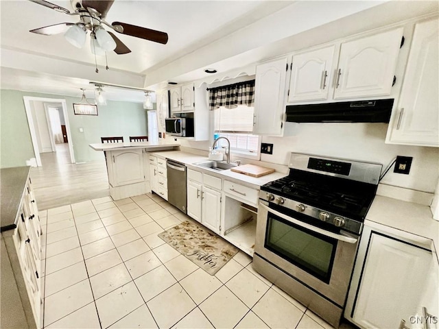 kitchen featuring light countertops, appliances with stainless steel finishes, a sink, and under cabinet range hood