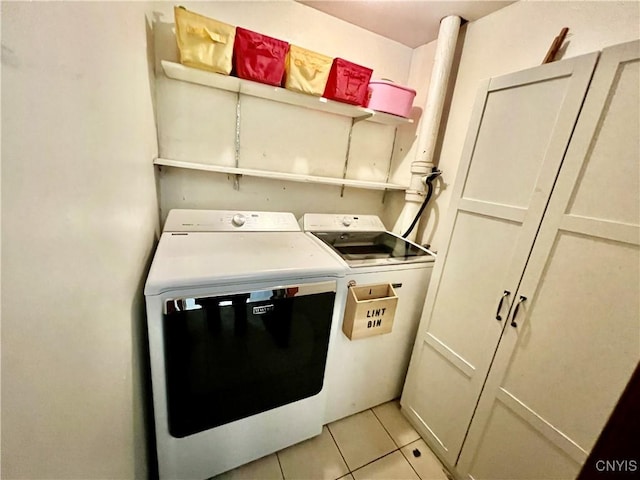 laundry area featuring laundry area, independent washer and dryer, and light tile patterned floors