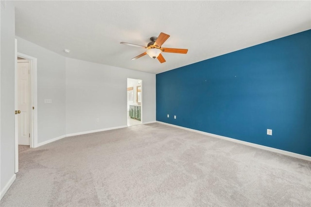 unfurnished room featuring baseboards, ceiling fan, and light colored carpet