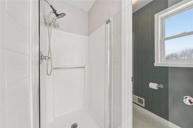 bathroom with a stall shower and visible vents