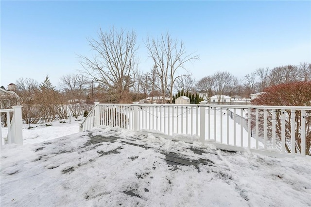 yard layered in snow featuring a garage