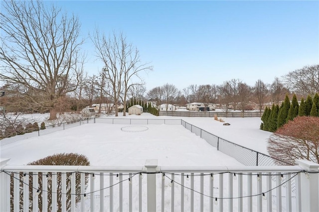 yard layered in snow featuring fence