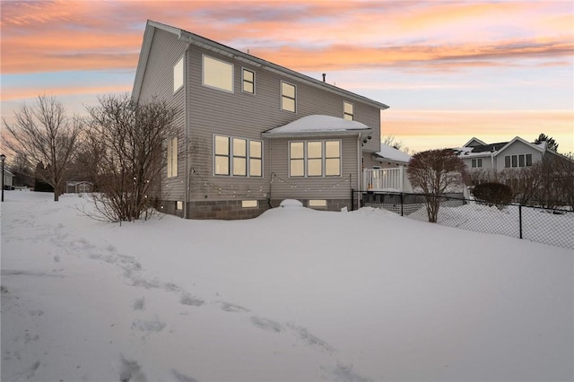 view of snow covered rear of property