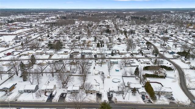 snowy aerial view with a residential view