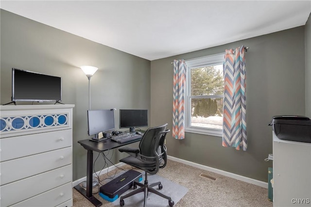 office area featuring light colored carpet, visible vents, and baseboards