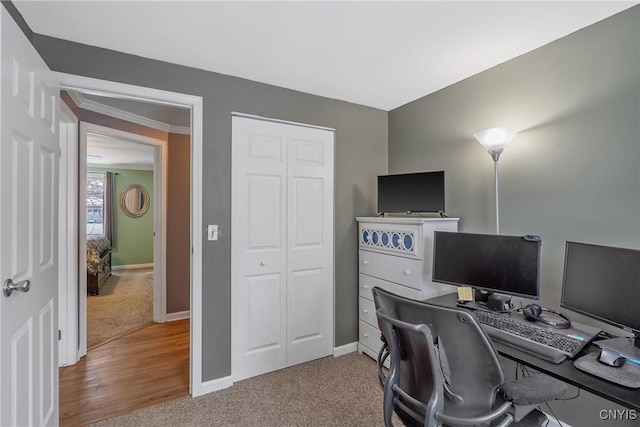 carpeted office space featuring baseboards