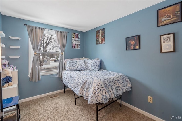 carpeted bedroom with visible vents and baseboards