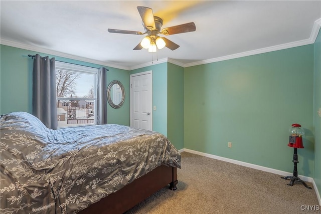 carpeted bedroom with crown molding, baseboards, and ceiling fan