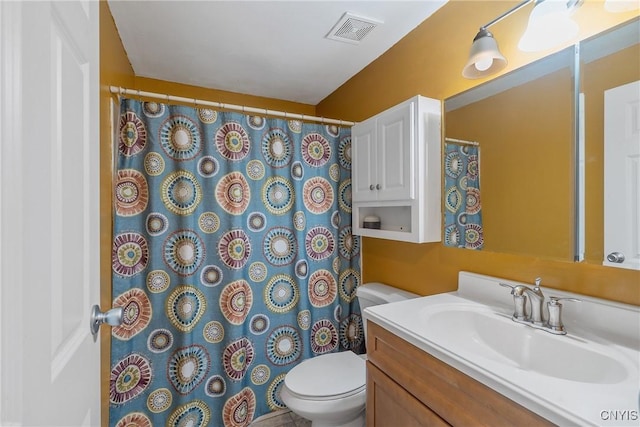 full bathroom with toilet, visible vents, and vanity