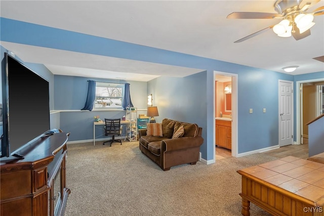 living area featuring ceiling fan, carpet, and baseboards