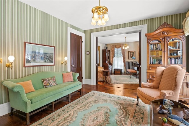 sitting room with a chandelier and wallpapered walls