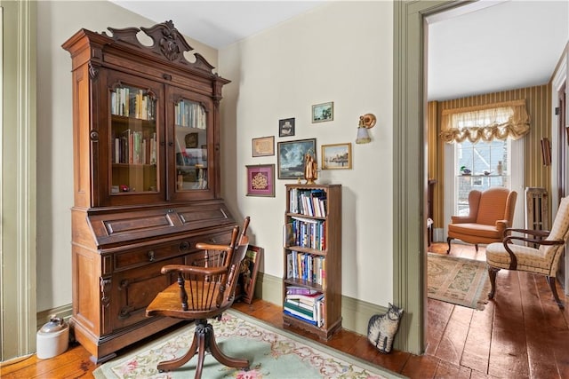 living area with baseboards and hardwood / wood-style floors