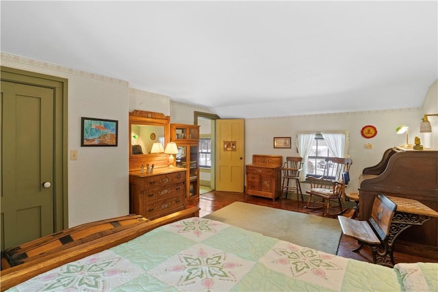 bedroom with vaulted ceiling, wood finished floors, and wallpapered walls