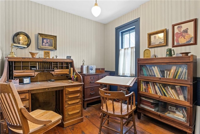 office space with dark wood-type flooring and wallpapered walls