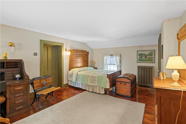 bedroom with dark wood-type flooring, radiator, vaulted ceiling, and wallpapered walls