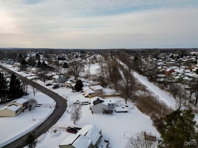 snowy aerial view with a residential view