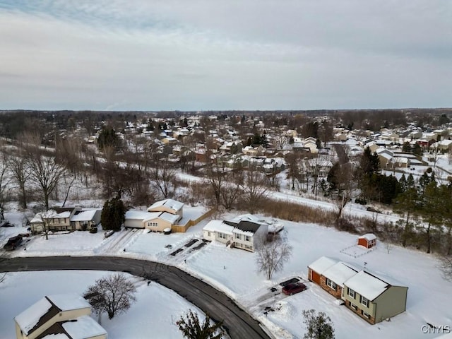 snowy aerial view with a residential view