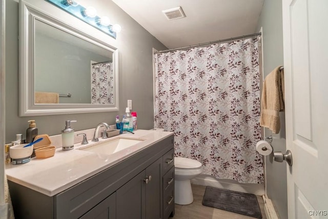 full bathroom featuring toilet, visible vents, and vanity