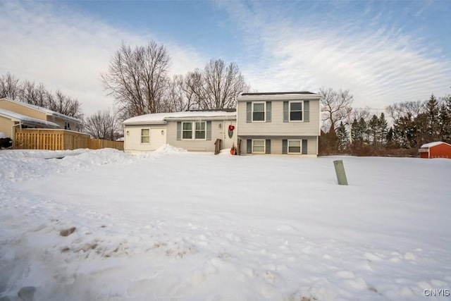 split level home with fence