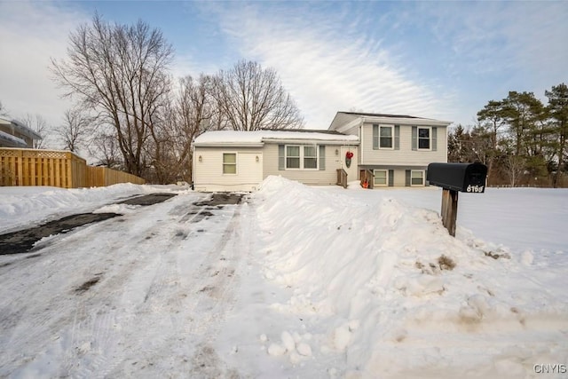 split level home with fence