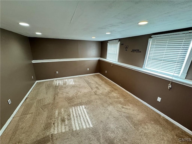 below grade area with carpet, baseboards, and recessed lighting