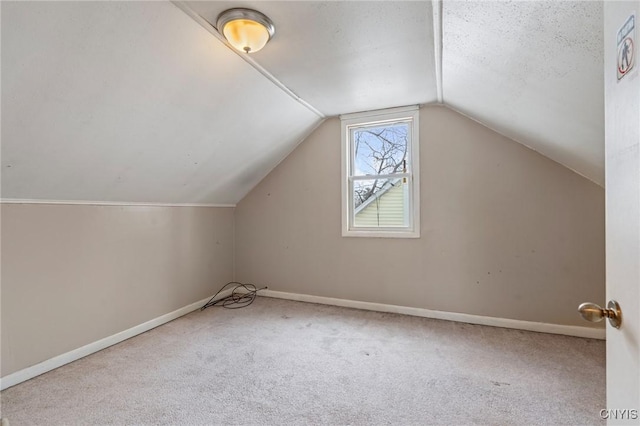 bonus room featuring vaulted ceiling, carpet flooring, and baseboards