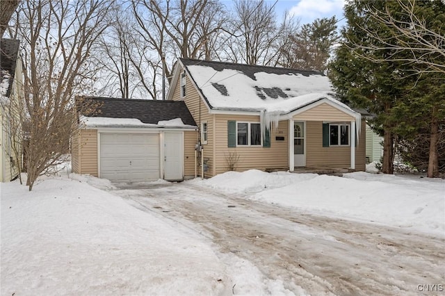 view of front of home featuring a garage and roof with shingles